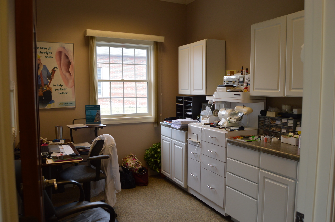 room with cabinets and various hearing aid repair equipment